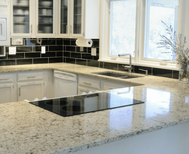White Granite Kitchen with Black Tile Backsplash | Reflections Granite & Marble